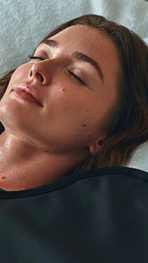 Client relaxing in an infrared sauna blanket
