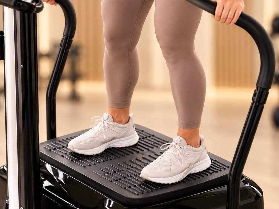 Client in sneakers standing on the vibration plate
