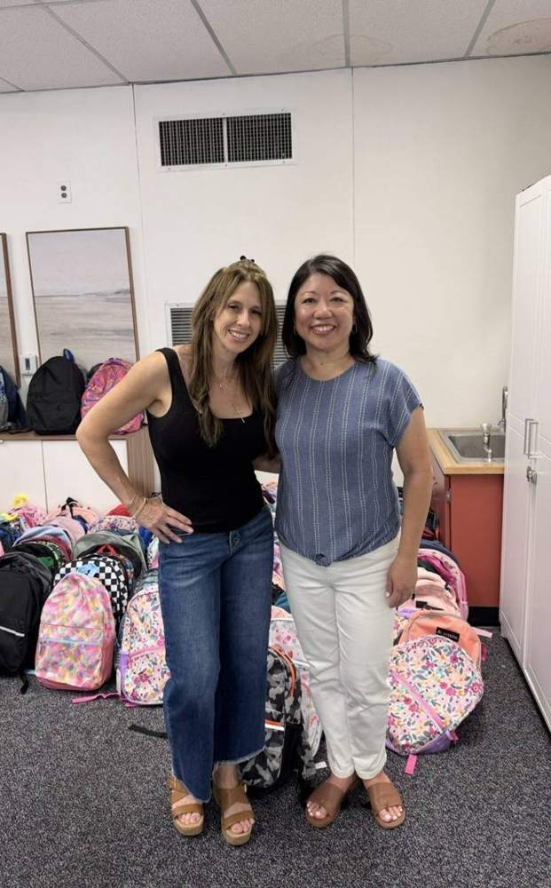 Jill with donated backpacks for local students