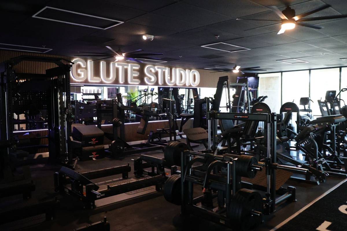 The GLUTE STUDIO sign glowing over the open training floor